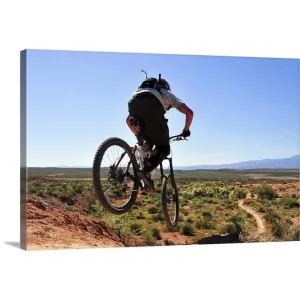 "A mountain biker catches some air on the JEM trail in southern Utah." Canvas Wall Art