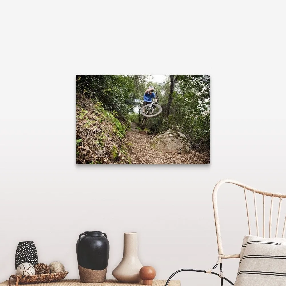 "A young man rides his downhill mountain bike on Knapps Castle Trail" Canvas Wall Art