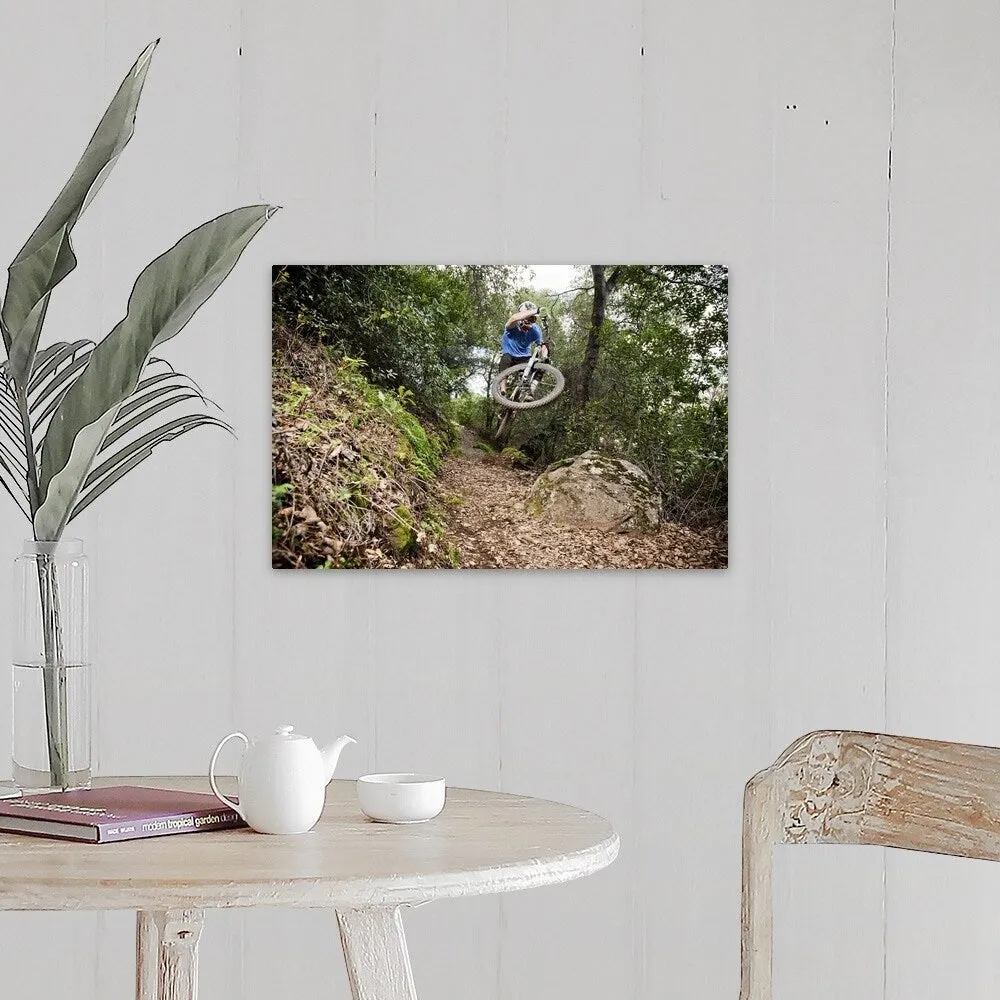 "A young man rides his downhill mountain bike on Knapps Castle Trail" Canvas Wall Art