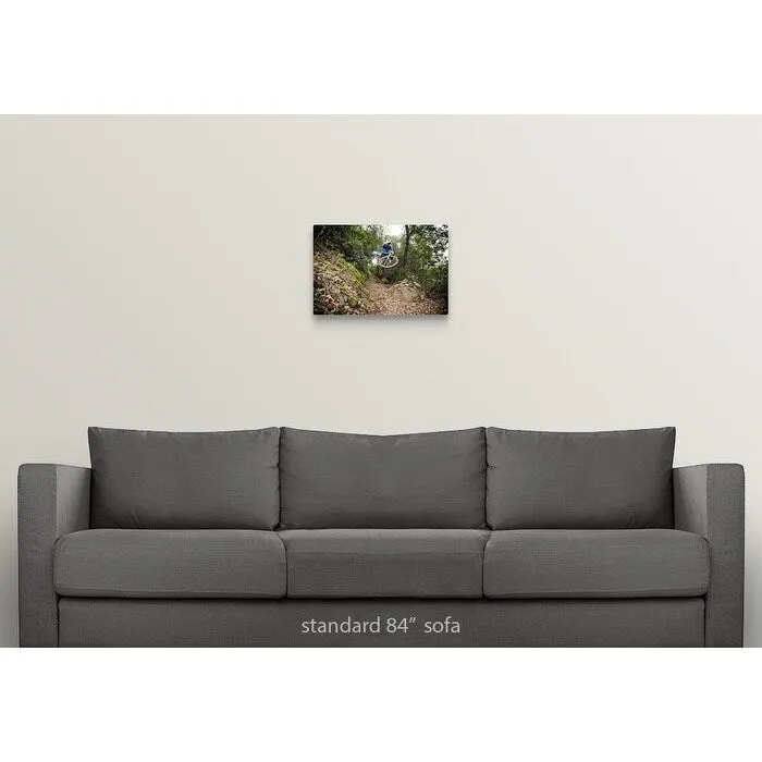 "A young man rides his downhill mountain bike on Knapps Castle Trail" Canvas Wall Art