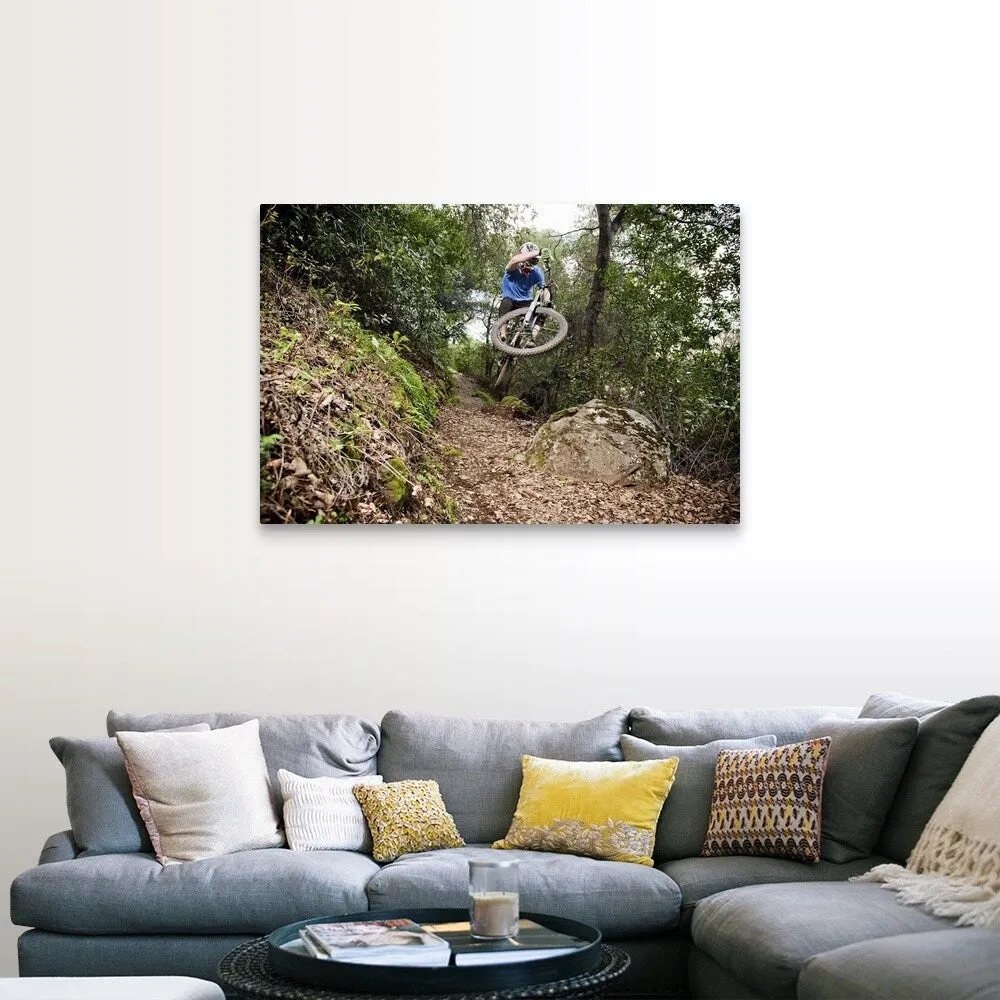 "A young man rides his downhill mountain bike on Knapps Castle Trail" Canvas Wall Art