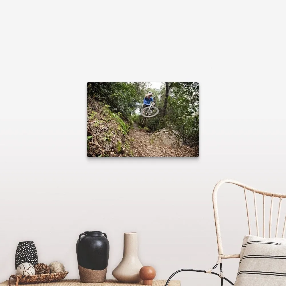 "A young man rides his downhill mountain bike on Knapps Castle Trail" Canvas Wall Art