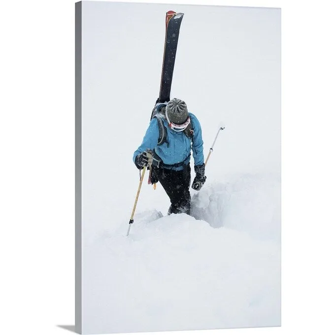 "A young woman packs her skis and kick steps up a section of trail" Canvas Wall Art