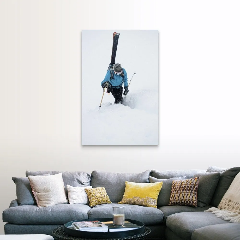 "A young woman packs her skis and kick steps up a section of trail" Canvas Wall Art